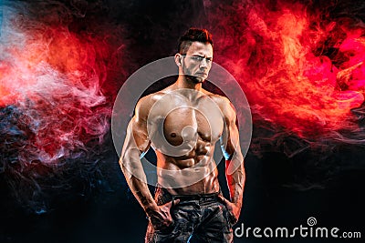 Strong bodybuilder man in military pants with perfect abs, shoulders, biceps, triceps, chest Stock Photo