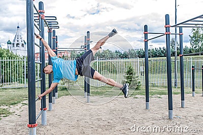 Strong and brave male athlete holding flag physical exercise, summer city. Fitness workout coach, active lifestyle Stock Photo