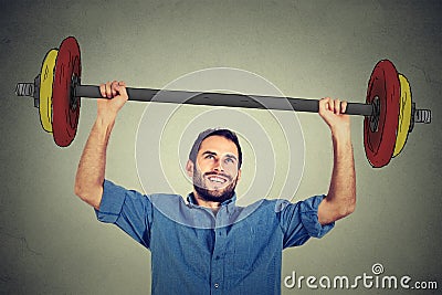 Strong business man lifting barbell with two hands Stock Photo