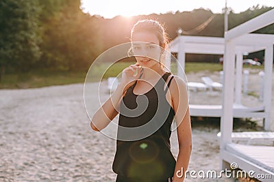 Strong confidence girl open arms under the sunrise at seaside Stock Photo