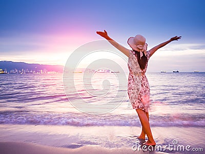 Strong confidence woman open arms under the sunrise at seaside. Stock Photo