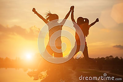Strong confidence woman open arms under the sunset Stock Photo