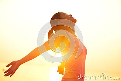 Strong confident woman open arms on beach Stock Photo