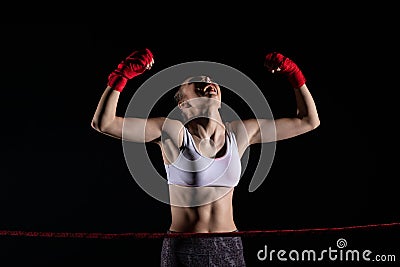 Strong emotions after winning the fight. A young MMA fighter. Hands raised up to prove a huge victory Stock Photo