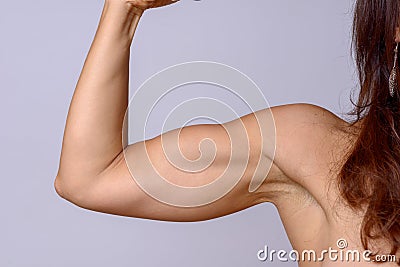 Strong fit mature woman flexing her arm muscles Stock Photo