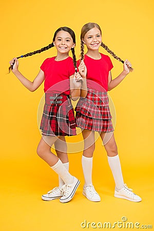 Strong hair. Children cheerful play with long braided hair. Happy moments. Kids girls sisters best friends in cheerful Stock Photo