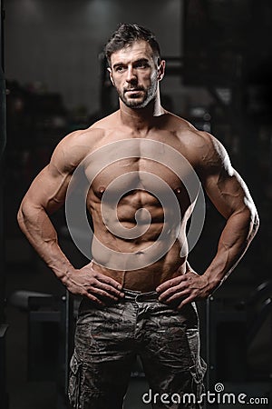 Strong and handsome athletic young man muscles abs and biceps Stock Photo