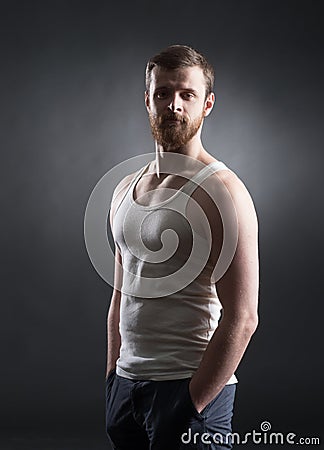Strong, handsome and bearded man on black Stock Photo