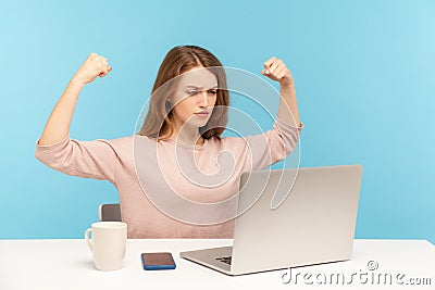 Strong independent confident woman boss raising hands showing biceps when talking on video call, looking proud Stock Photo