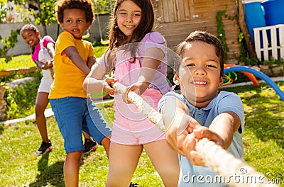 Strong kids pull rope in the competitive game Stock Photo