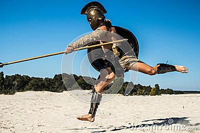 Strong legionnaire`s legs in a jump on the opponent Stock Photo