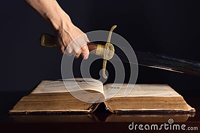 Young Athletic Man with His Bible and Sword Stock Photo