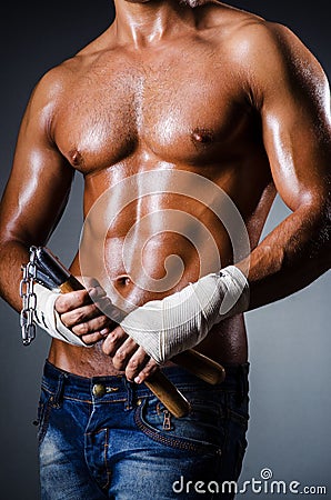 Strong man with nunchaku Stock Photo