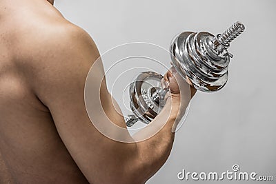 Strong man working out with dumbbell Stock Photo