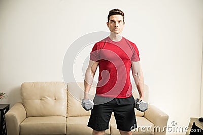 Strong man working out at home Stock Photo