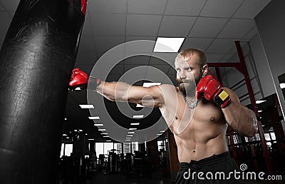 Strong muscular man boxing at the gym. Stock Photo