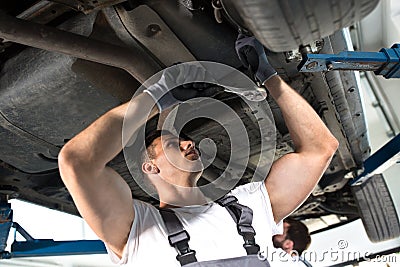 Strong repairman under the car Stock Photo
