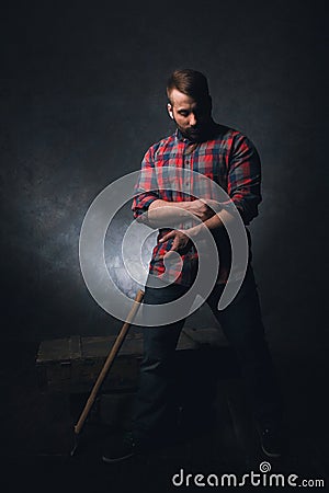 Strong rural worker on dark background Stock Photo