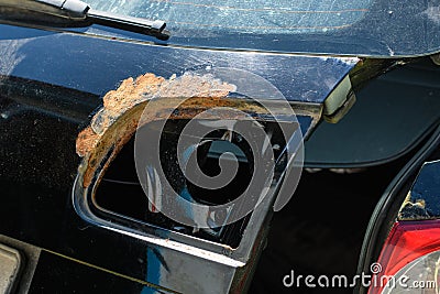 Strong rust on the rear of the car under the headlight. Stock Photo