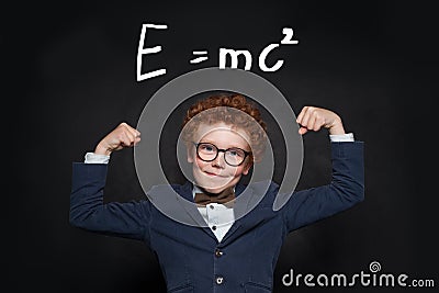 Strong and smart child student on blackboard with science formula Stock Photo