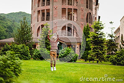 Strong, smart and funny little boy playing outdoors, wearing eyeglasses Stock Photo