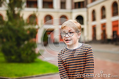 Strong, smart and funny little boy playing outdoors, wearing eyeglasses Stock Photo