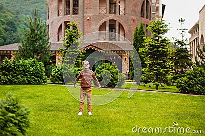 Strong, smart and funny little boy playing outdoors, wearing eyeglasses Stock Photo