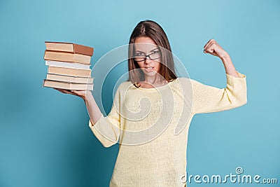 Strong smart girl holding books in one hand wearing eyeglasses Stock Photo