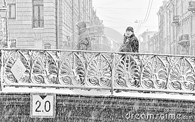 The strong snowstorm in Saint Petersburg. People walking along Demidov bridge. Editorial Stock Photo