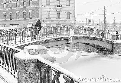 The strong snowstorm in Saint Petersburg. People walking along Sennoy bridge. Editorial Stock Photo