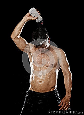 Strong sport man pouring water on his head sweating after training gym bodybuilding workout Stock Photo