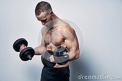 Strong sport sirtless man making weightlifting with dumbbells Stock Photo