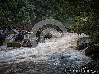 Strong water current flowing in stream. a lot of water from waterfall in rainy season. Stock Photo