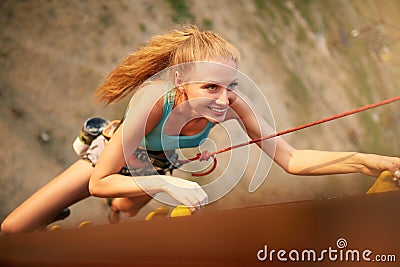 Strong woman and business success concept. Top view of young caucasian pretty woman practicing climbing on artificial Stock Photo