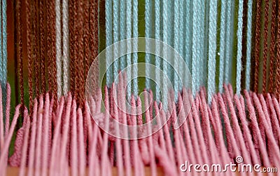 Strong woolen threads woven into the loom Stock Photo