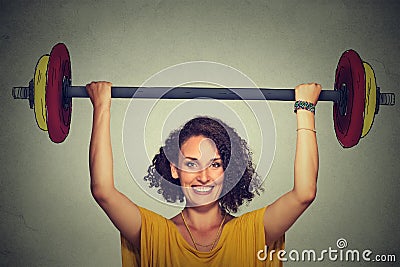 Strong young man lifting barbell above head with two hands Stock Photo