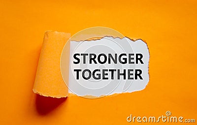 Stronger together symbol. Words Stronger together appearing behind torn orange paper. Business, motivational and Stronger together Stock Photo