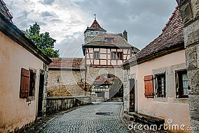 The stronghold gate in the medieval town Rothenburg ob der Tauber in a beautiful light , Germany Stock Photo