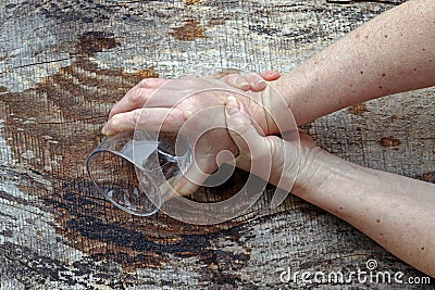 Strongly trembling hands of an older woman Stock Photo