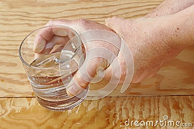 Strongly trembling hands of an older woman Stock Photo