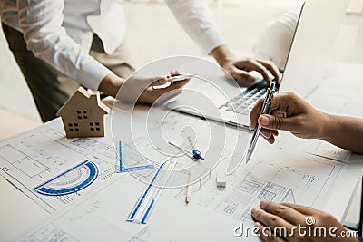 Structural engineering designers are working on the blueprints and analyzing them together Stock Photo