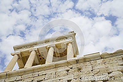 Structure supported by four pillars atop stone wall Editorial Stock Photo