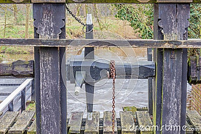 Structure to open the floodgates on the weir next to the Leumolen or Sint-Ursulamolen watermill on the Leubeek river Stock Photo