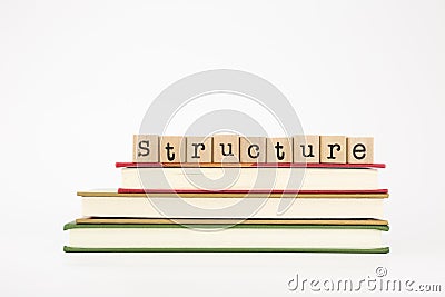 Structure word on wood stamps and books Stock Photo