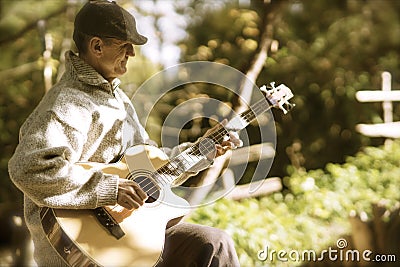 Strumming guitar in afternoon light Stock Photo