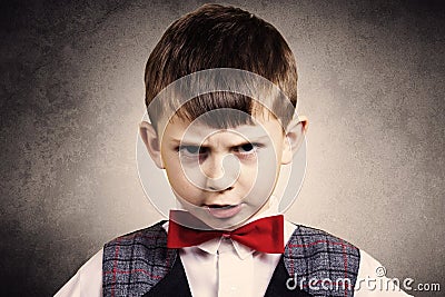 Stubborn,sad,upset little boy,child over grey backgro Stock Photo