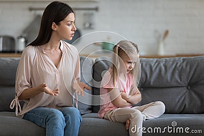 Stubborn upset little daughter ignoring strict mother, family conflict Stock Photo