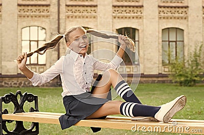 Student adorable child in formal uniform relaxing outdoors. Pleasant minutes of rest. Time to relax and have fun Stock Photo