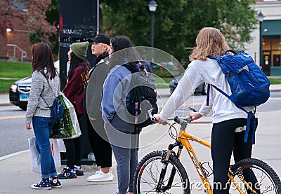 Student on bicycle waiting at campus intersection Editorial Stock Photo