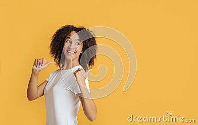 Student, blogger recommends great offer. Happy african american lady with showing thumbs back to free space Stock Photo